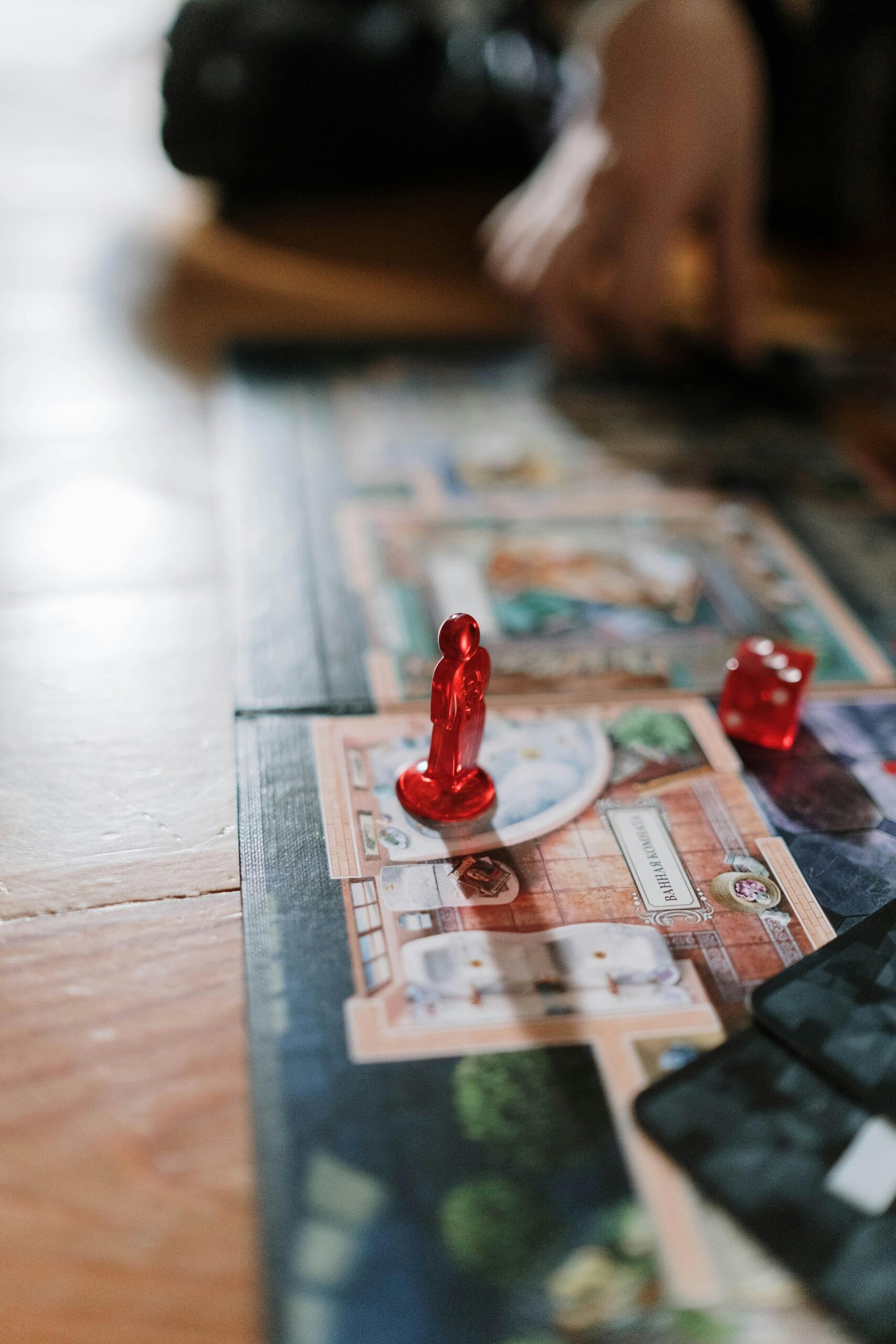 Close-up image of a board game in play with red tokens, highlighting strategy and focus.
